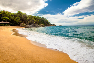 Sea surf on the beach of Santa Cristina in Lloret de Mar