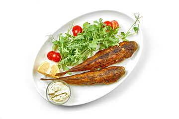 Fried gobies in a white plate. Close-up, selective focus. White background