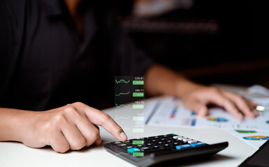 Naklejka premium Businessman using calculator with planning business, idea for marketing to project success. Business people analysis data figures to plan business strategies. Business plan growth concept.