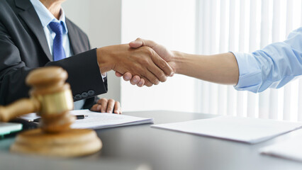 Lawyer and legal concept, Businessman and senior lawyer shake hands after successful deal contract
