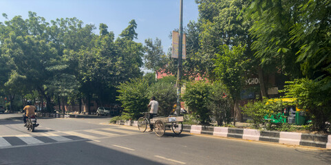 A labour poor man using hi rikshaw to do his work