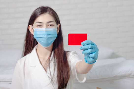 wearing gloves with a card on a white background.