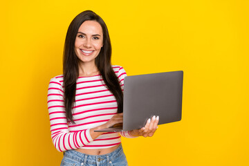 Photo of young attractive smiling professional programmer coder new software isolated on yellow color background