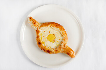 Adjarian khachapuri traditional georgian dish with sulguni cheese filled bread and egg yolk