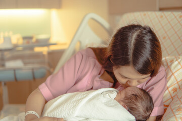 Obraz na płótnie Canvas Newborn baby in mother's embrace, warmth, mother's love, baby.