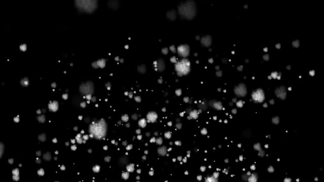 Animation of heavy snowfall. Snowflakes on black background fall straight down,