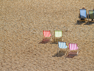 Deck chairs on Brighton Beach view below