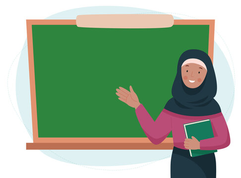 Female teacher in classroom. Muslim woman in a hijab showing something on a chalkboard. School and learning concept. Teachers day. 