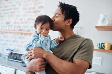 Down syndrome baby bonding with father in their home, kiss and affection by caring parent for...