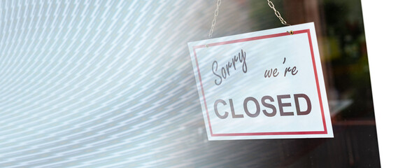 Closed sign hanging behind a store window; panoramic banner