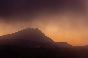 Sainte Victoire mountain in the sun of an autumn morning with thick fog