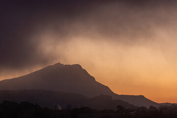 Sainte Victoire mountain in the sun of an autumn morning with thick fog