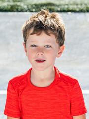 portrait of an adorable blue eyed Caucasian boy outdoors