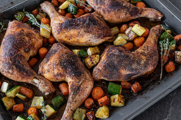 Homemade chicken with vegetables on a baking tray