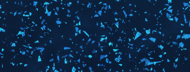 Dark navy blue sparkling background from big foil turquoise sequins, macro. Texture backdrop with...