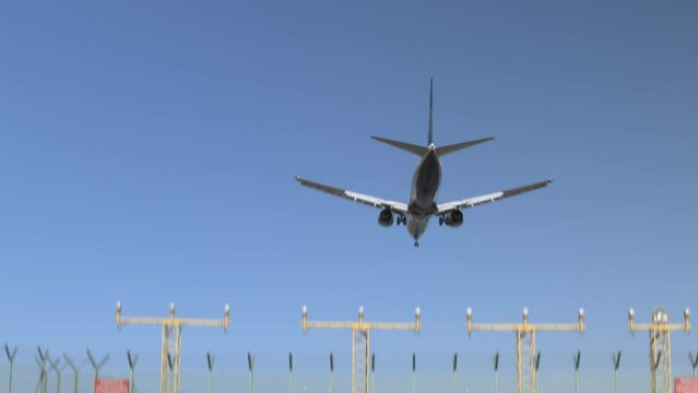 Passenger plane landing at Milan airport on a sunny day
