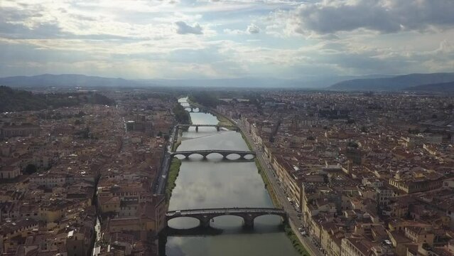 Sun beam aerial view of bridges over Arno River in Florence, Italy