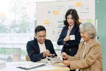 Group of business people sitting around the office desk and discussing the project together.Business meeting time.