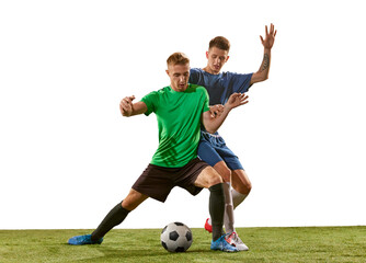 Two soccer players in action, motion on green grass flooring isolated over white background....