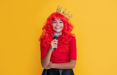 glad kid in crown with microphone on yellow background