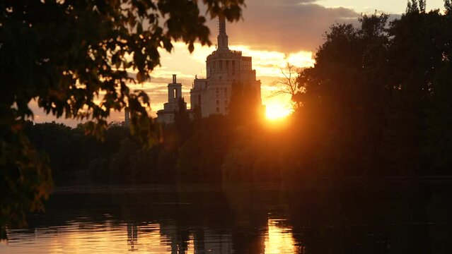 Autumn sunset over Free Press House (Casa Presei Libere in Romanian language) and Herastrau Park lake from Bucharest. Travel to Romania, amazing landscape in the heart of Bucharest, 2022.