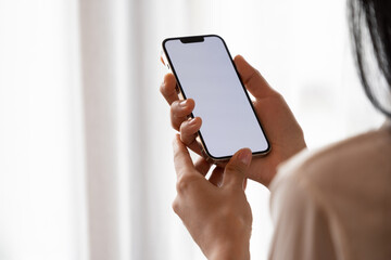 female hand holding a white screen phone