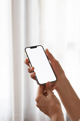 female hand holding a white screen phone