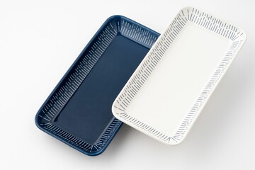 Set of blue and white luxury ceramic kitchen utensils on a white background.