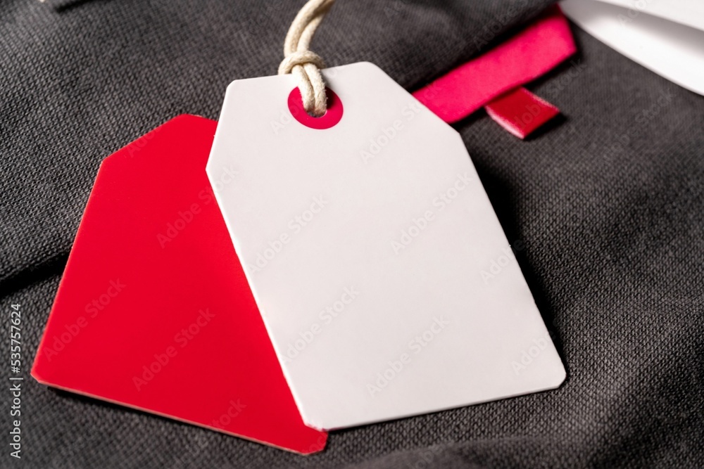 Poster closeup shot of white red clothing tags on a string with copy space