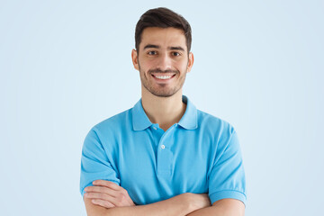Close up portrait of smiling handsome guy in blue polo shirt, isolated on blue background