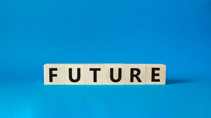Future symbol. Concept word Future on wooden cubes. Beautiful blue background. Business and Future concept. Copy space.
