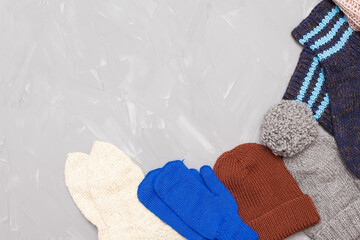 Knitted surface of woolen things as a background. Close-up of soft fabric red color knitted patterns texture. Warm winter clothing. Background textile surface with copy space for text