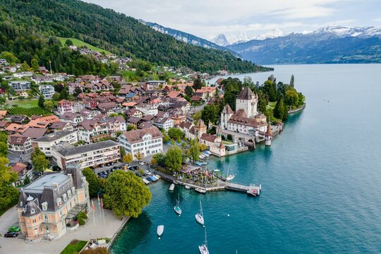 Aerial view of the Oberhofen Castle and the coastal city in Switzerland