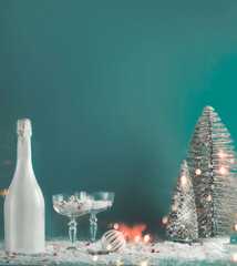 Christmas and New Year background with bottle of champagne , fancy glasses with snow, Christmas...