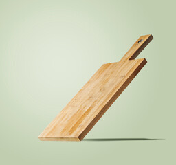 Empty cutting board with shadow at light background.