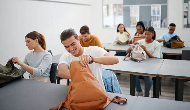 University students in a classroom, learning education at college in a diversity rich environment. Young men and women are excited to study and learn as they search for stationary in backpack.