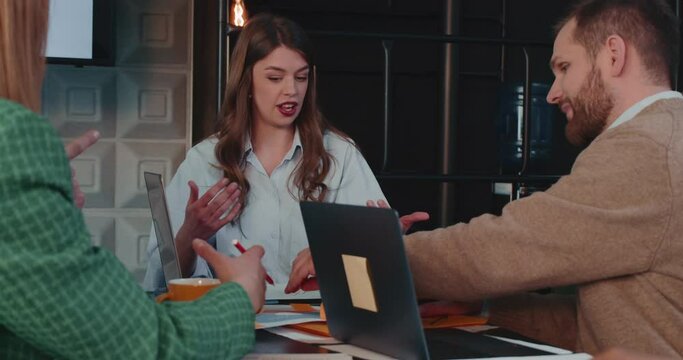 Stressed serious manager, CEO businesswoman dealing with conflict talking to colleagues at office meeting slow motion.