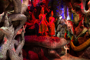 Tunnel cave underground for thai people travel visit and respect praying blessing holy worship mystical ancient naga or antique naka statue at Wat Maniwong or Mani Wong temple in Nakhon Nayok Thailand - obrazy, fototapety, plakaty