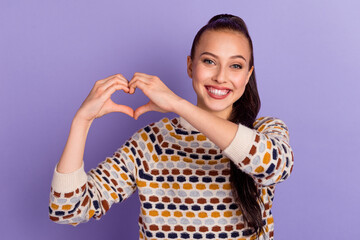 Photo of adorable young lady smiling showing hands arms heart isolated vibrant color background