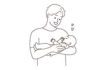 Happy father holding baby in arms 