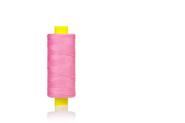 skein of thread pink colors macro on a white background