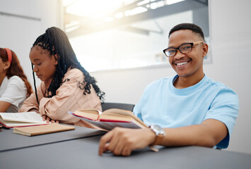 Reading, books and language student portrait studying in classroom for university education, knowledge and scholarship. College black man in lecture with smile for research, scholarship or learning