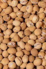 Fotobehang Vertical shot of roasted soy sauce peanuts © Stephen Mihalchik/Wirestock Creators