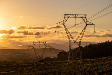 High voltage cables with the sky at sunset in the background