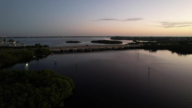 Drone shot of bridge with cars over the Braden River at sunrise, Florida