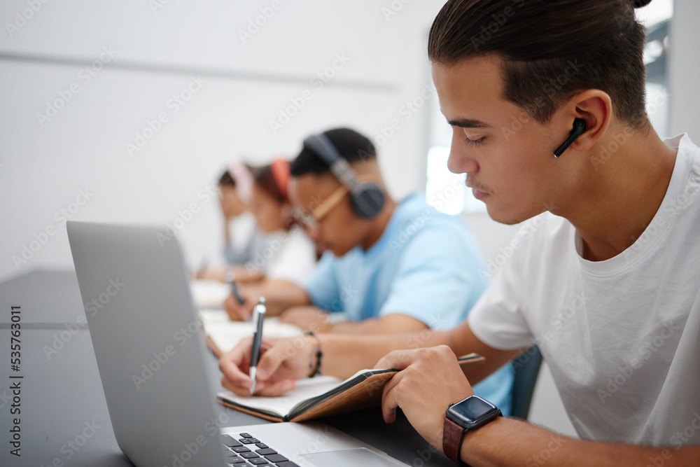 Poster studying, notebook and laptop with students in university classroom, library or workspace for learni