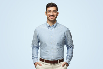 Smart businessman smiling at camera, wearing transparent glasses, isolated on blue background - Powered by Adobe