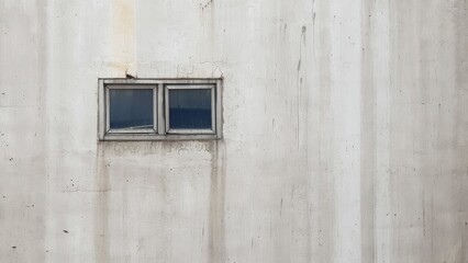 Small window on concrete wall.