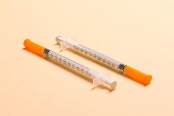 Top view of two insulin syringe at colorful background. High level of glucose concept