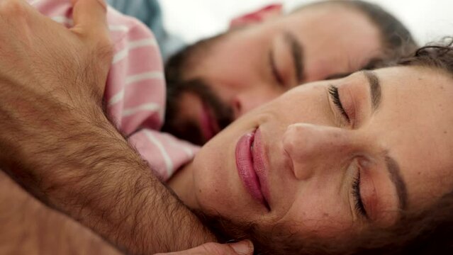 Health, love and couple sleeping and hug in bedroom at home. Man and woman from Israel in bed asleep, rest together in apartment or hotel. Sleep, relax and dream, happy marriage and healthy lifestyle